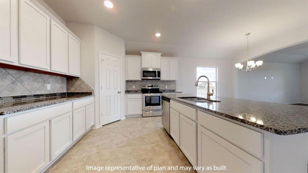 Kitchen featuring a center island with sink, light stone countertops, white cabinets, stainless steel appliances, and pendant lighting Kitchen featuring a center island with sink, light stone countertops, white cabinets, stainless steel appliances, and pendant lighting