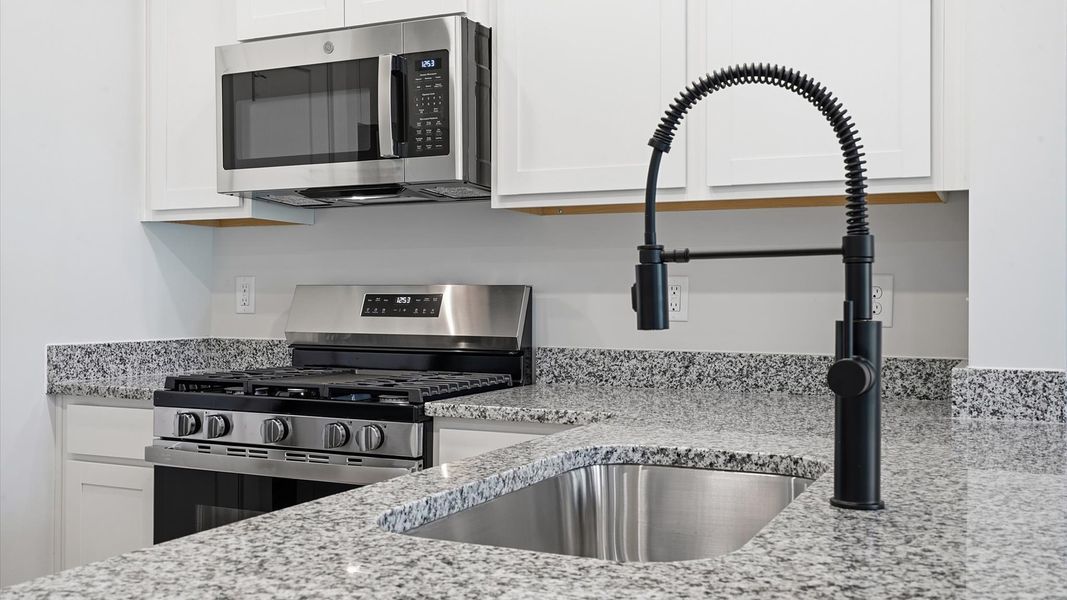 Thoughtfully crafted kitchen featuring stylish hardware and polished finishes Thoughtfully crafted kitchen featuring stylish hardware and polished finishes