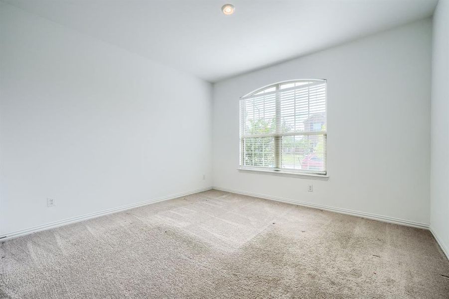 Carpeted spare room featuring baseboards Carpeted spare room featuring baseboards