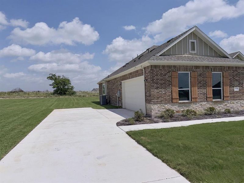 Front exterior of a new home in Windmill Creeks, Weatherford, TX, highlighting curb appeal (Image 15). Front exterior of a new home in Windmill Creeks, Weatherford, TX, highlighting curb appeal (Image 15).