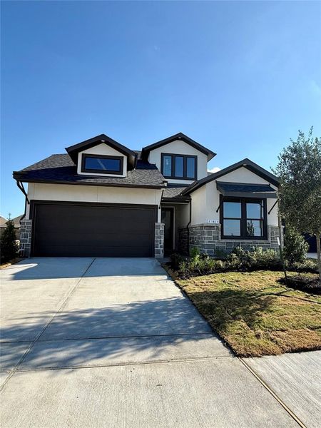 Front exterior of a new home in Bridgeland 45', 50', 70', Cypress, TX, highlighting curb appeal (Image 1). Front exterior of a new home in Bridgeland 45', 50', 70', Cypress, TX, highlighting curb appeal (Image 1).