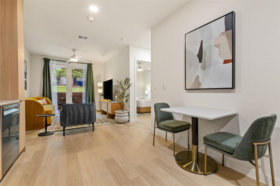 Warm wood flooring and an open layout create an inviting sense of flow throughout.