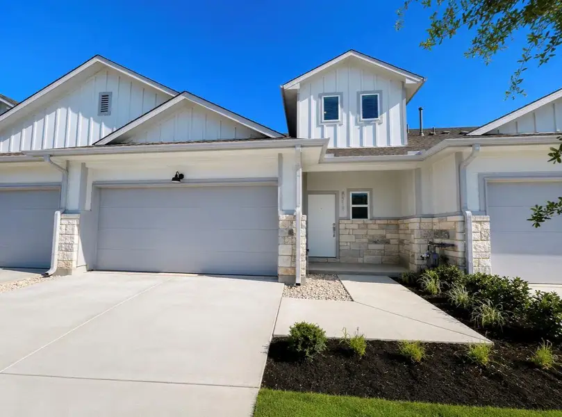 Front exterior of a new home in Wellspring, Round Rock, TX, highlighting curb appeal (Image 19).