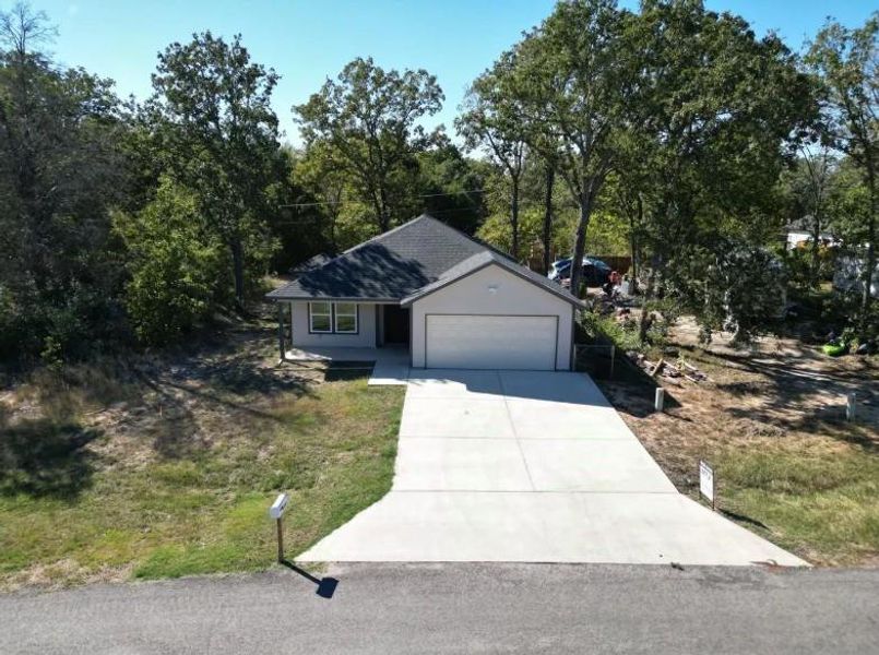 Ranch-style home with concrete driveway and a garage
