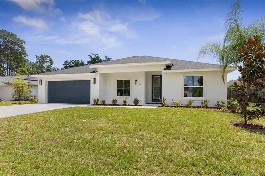 Front exterior of a new home in , Palm Coast, FL, highlighting curb appeal (Image 2). Front exterior of a new home in , Palm Coast, FL, highlighting curb appeal (Image 2).