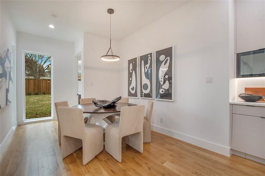 Dining area with light hardwood / wood-style floors