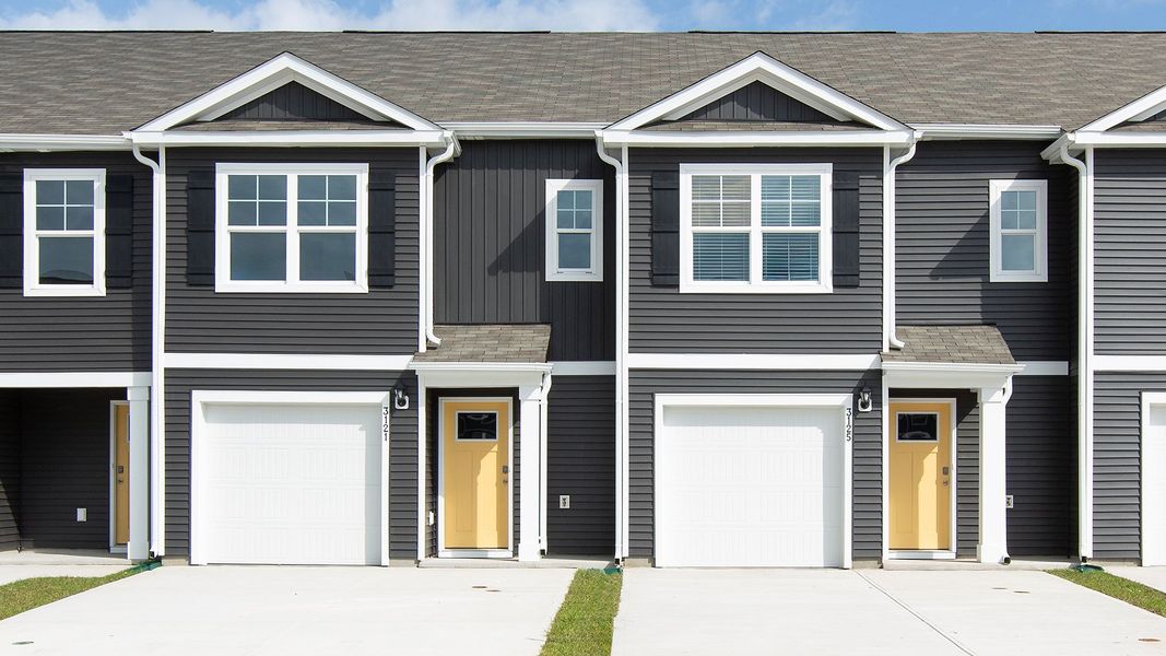 Front exterior of a new home in Waterside Townhomes, Surf City, NC, highlighting curb appeal (Image 1).