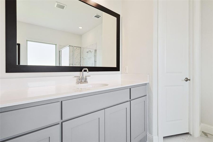 Bathroom featuring vanity and an enclosed shower