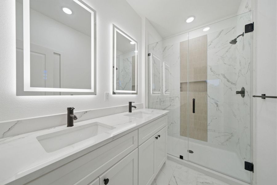 Primary bathroom features double sinks and walk-in shower. Primary bathroom features double sinks and walk-in shower.
