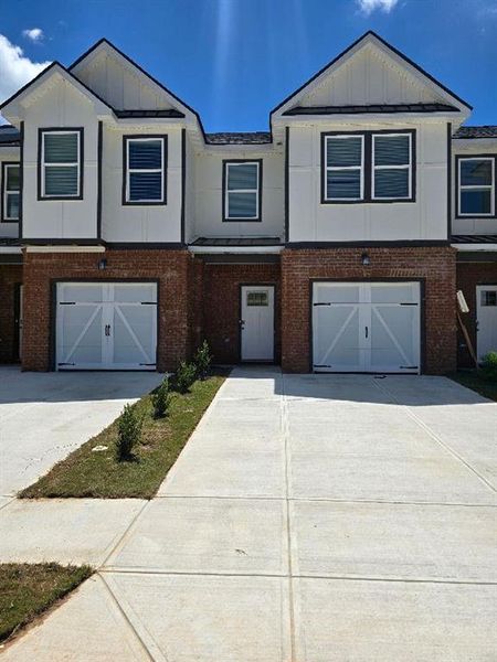Front exterior of a new home in The Grove At Mundy Mill, Gainesville, GA, highlighting curb appeal (Image 30). Front exterior of a new home in The Grove At Mundy Mill, Gainesville, GA, highlighting curb appeal (Image 30).