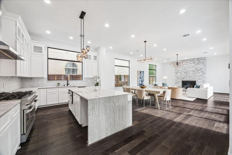 The kitchen is anchored by a beautiful waterfall island, blending sleek design with functionality and creating a dramatic focal point for everyday living and entertaining.