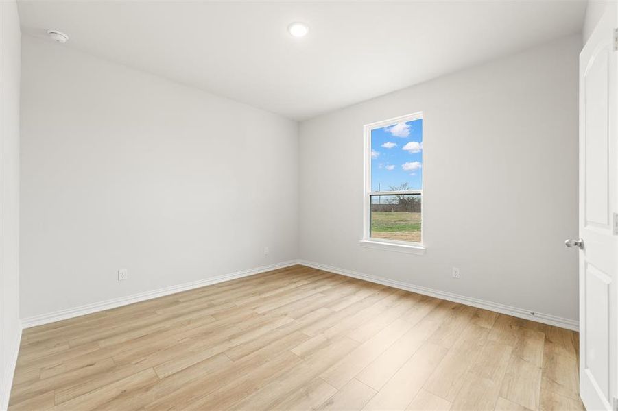 Spare room featuring light wood-style floors and recessed lighting