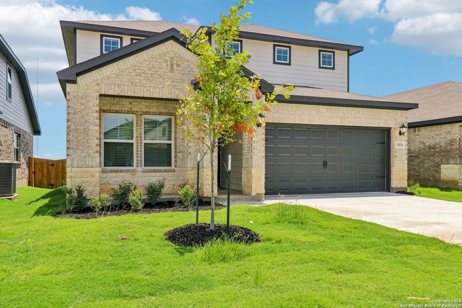 Front exterior of a new home in Sagebrooke - Premier Series, San Antonio, TX, highlighting curb appeal (Image 20). Front exterior of a new home in Sagebrooke - Premier Series, San Antonio, TX, highlighting curb appeal (Image 20).