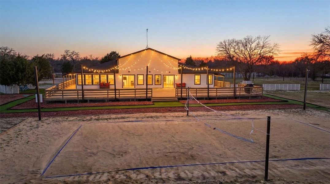 Volleyball court and back deck at dusk.