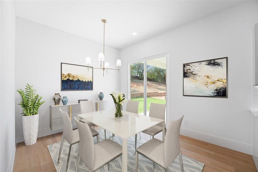 Dining room with a chandelier, light wood-style flooring, and recessed lighting