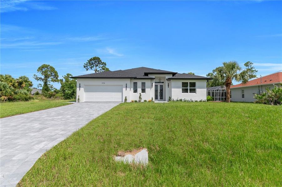 Front exterior of a new home in , North Port, FL, highlighting curb appeal (Image 1). Front exterior of a new home in , North Port, FL, highlighting curb appeal (Image 1).