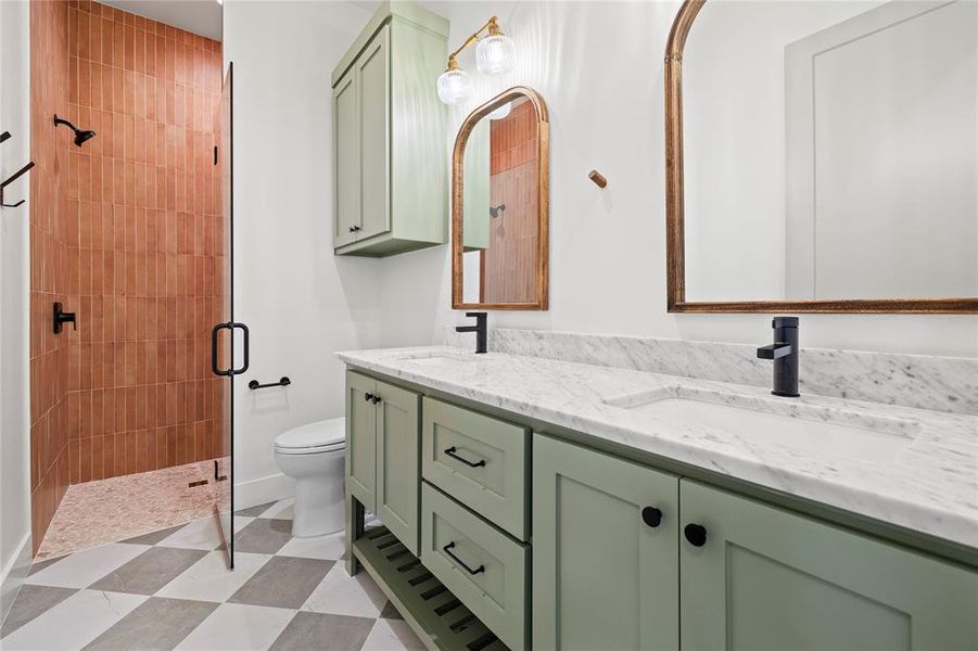 Full bath with a shower stall and double vanity