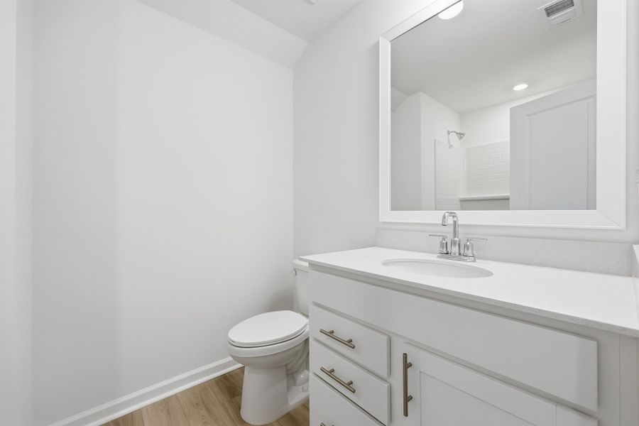 Full bathroom featuring vanity, light wood-type flooring, and a shower Full bathroom featuring vanity, light wood-type flooring, and a shower