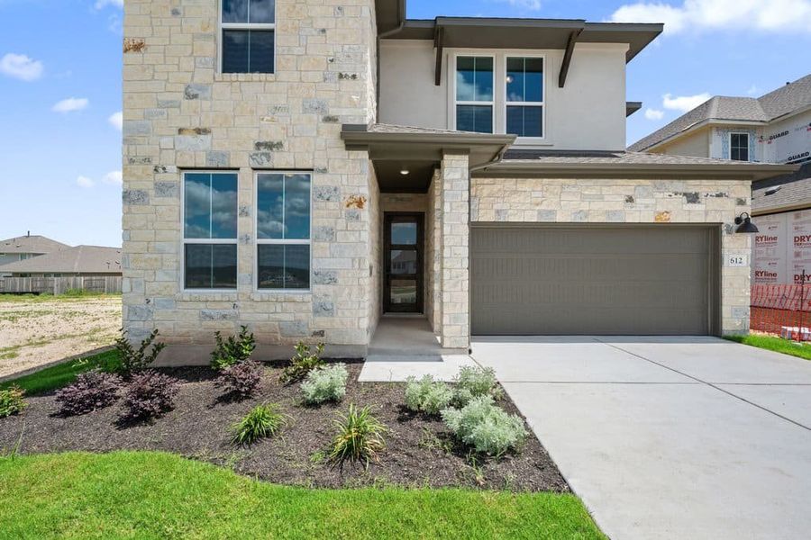 Front exterior of a new home in Lariat, Liberty Hill, TX, highlighting curb appeal (Image 25).