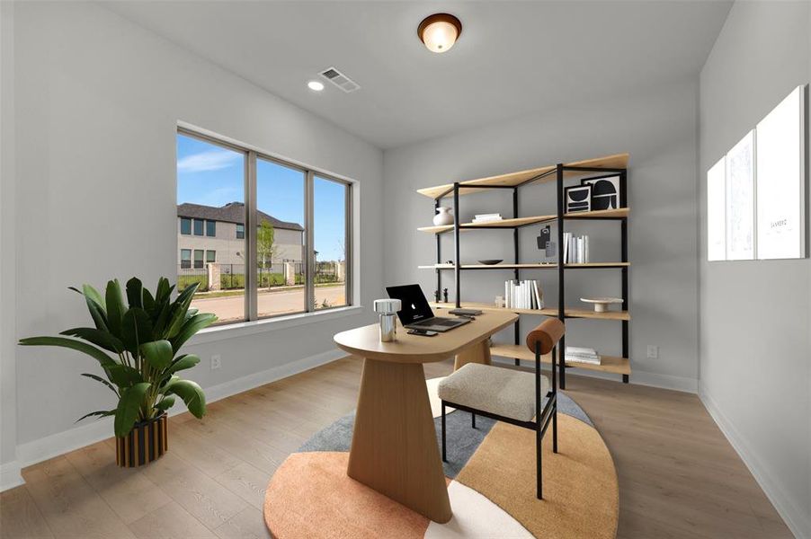 Office space with light wood-style flooring and recessed lighting
