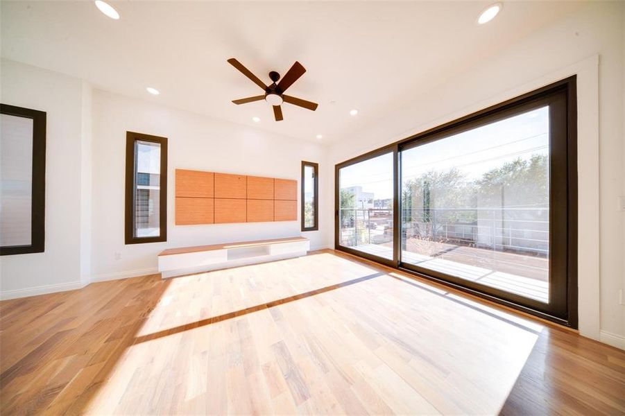 Unfurnished living room featuring light hardwood / wood-style floors and ceiling fan