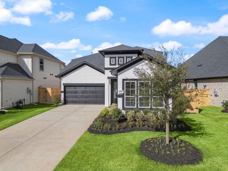 Front exterior of a new home in Sienna 45', 50', Missouri City, TX, highlighting curb appeal (Image 2). Front exterior of a new home in Sienna 45', 50', Missouri City, TX, highlighting curb appeal (Image 2).