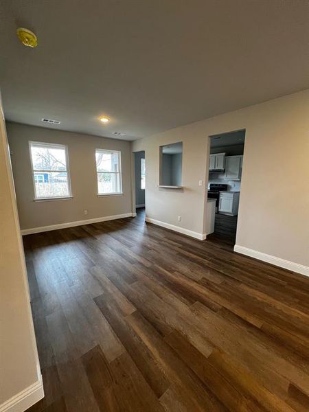 Unfurnished living room featuring dark hardwood / wood-style flooring