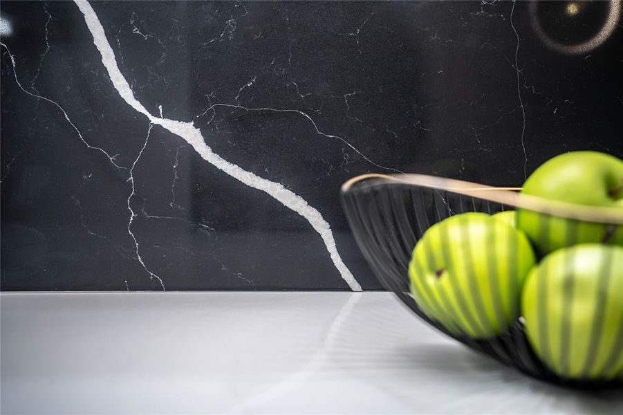 Beautiful quartz slab backsplash, contributing to a seamless design in the kitchen.