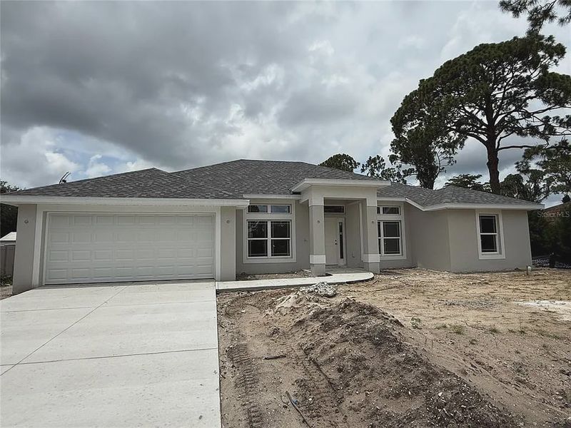 Front exterior of a new home in North Port, North Port, FL, highlighting curb appeal (Image 1). Front exterior of a new home in North Port, North Port, FL, highlighting curb appeal (Image 1).