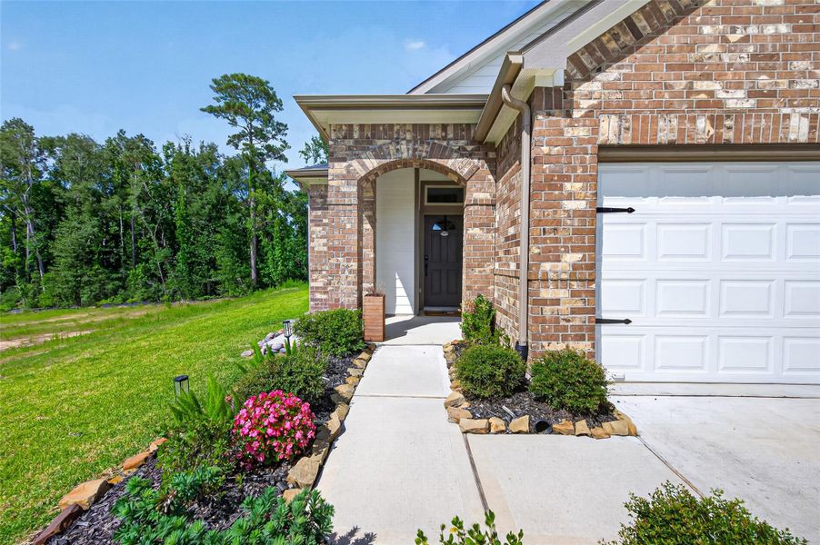 Charming brick home with a welcoming front porch, beautiful landscaping, and a well-maintained walkway leading to the entrance. The attached garage adds convenience, while the surrounding greenery offers a serene, natural backdrop. Charming brick home with a welcoming front porch, beautiful landscaping, and a well-maintained walkway leading to the entrance. The attached garage adds convenience, while the surrounding greenery offers a serene, natural backdrop.