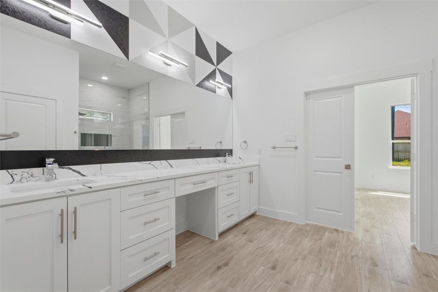 A massive vanity area completes the suite, featuring dual sinks and plenty of storage. A massive vanity area completes the suite, featuring dual sinks and plenty of storage.