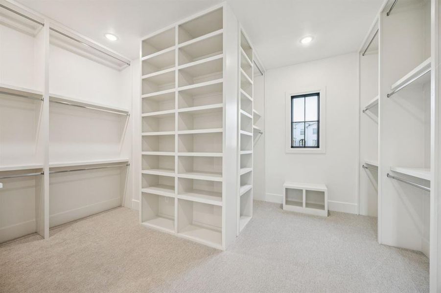 Spacious closet with carpet flooring Spacious closet with carpet flooring