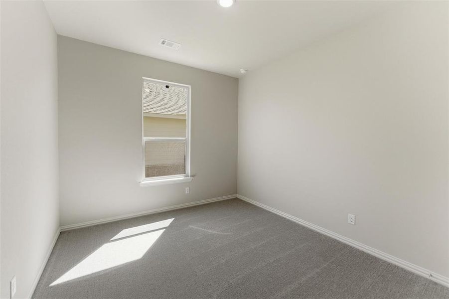 Empty room with carpet flooring and baseboards