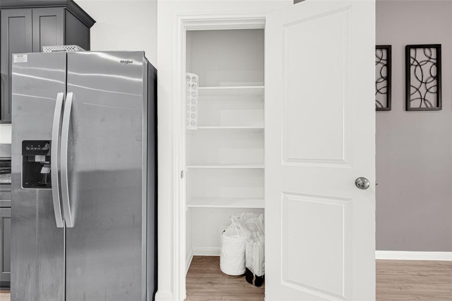 lose-up view of the kitchen's built-in stainless steel refrigerator and surrounding clean cabinetry.