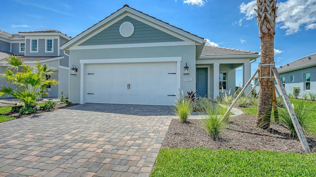 Front exterior of a new home in Palmera Real Estate and Homes for Sale in Venice, FL - Neal Communities, Venice, FL, highlighting curb appeal (Image 1). Front exterior of a new home in Palmera Real Estate and Homes for Sale in Venice, FL - Neal Communities, Venice, FL, highlighting curb appeal (Image 1).