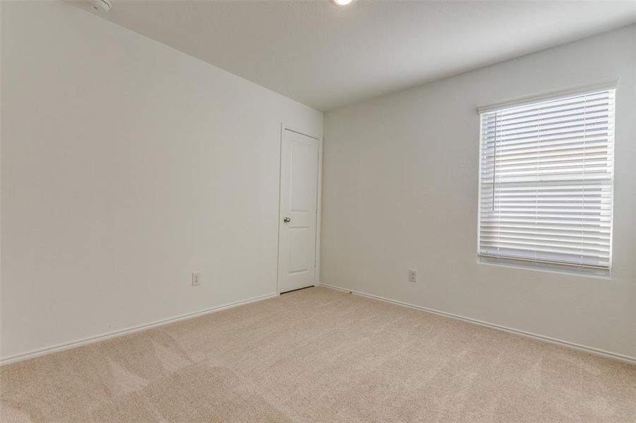 Unfurnished room with light colored carpet