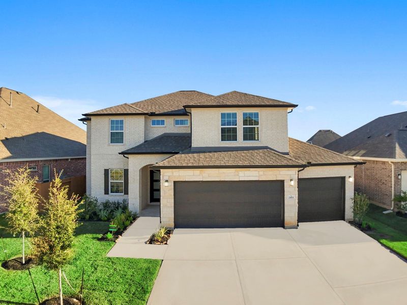 The front elevation of the San Marcos Floor Plan by CastleRock Communities stands out with its elegant brick-and-stone design, spacious three-car garage, and beautifully landscaped curb appeal.