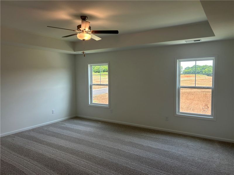 A spacious, naturally illuminated room boasts plus
