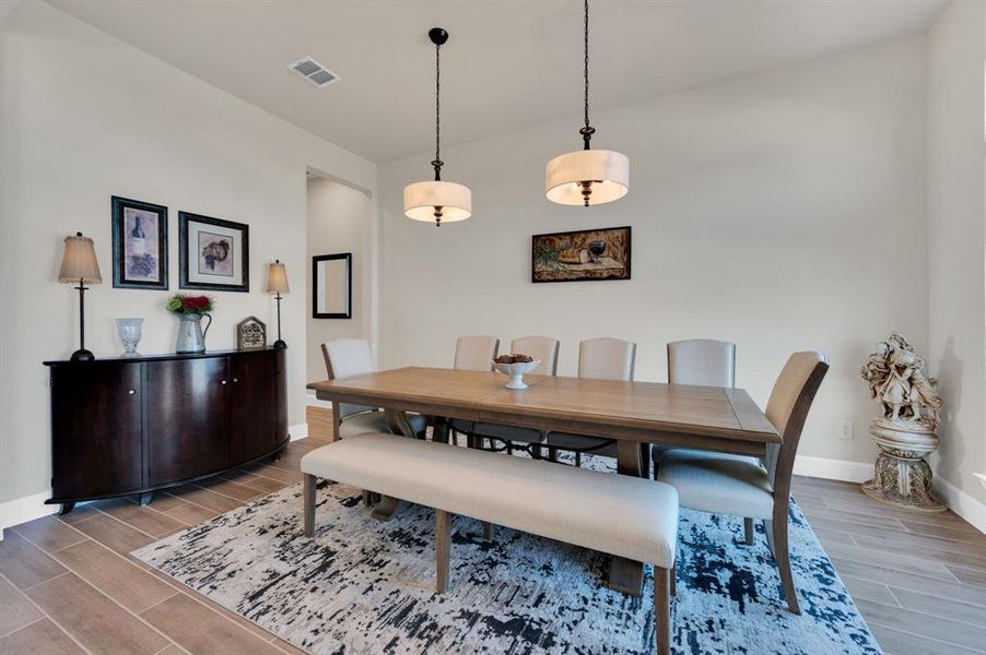 Expansive Dining room is large enough to fit the largest of tables with dual drum shade fixtures! The custom roller shades offer privacy when needed.