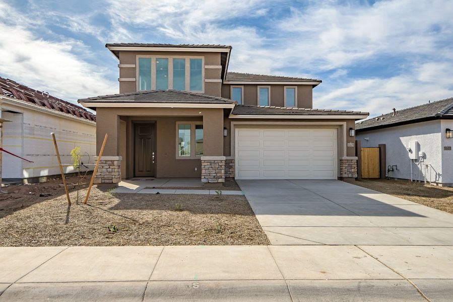 Front exterior of a new home in Icon at Thunderbird, Glendale, AZ, highlighting curb appeal (Image 6).