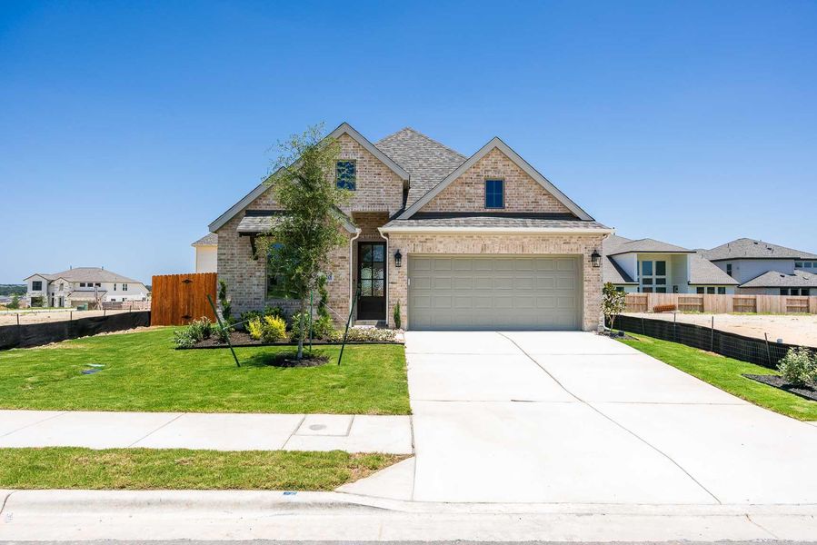 Front exterior of a new home in Lariat 45', Liberty Hill, TX, highlighting curb appeal (Image 2).
