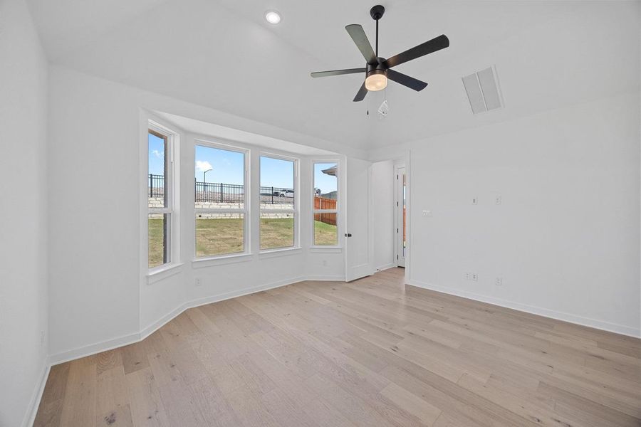 Unfurnished room featuring light wood-style floors, a ceiling fan, lofted ceiling, and recessed lighting