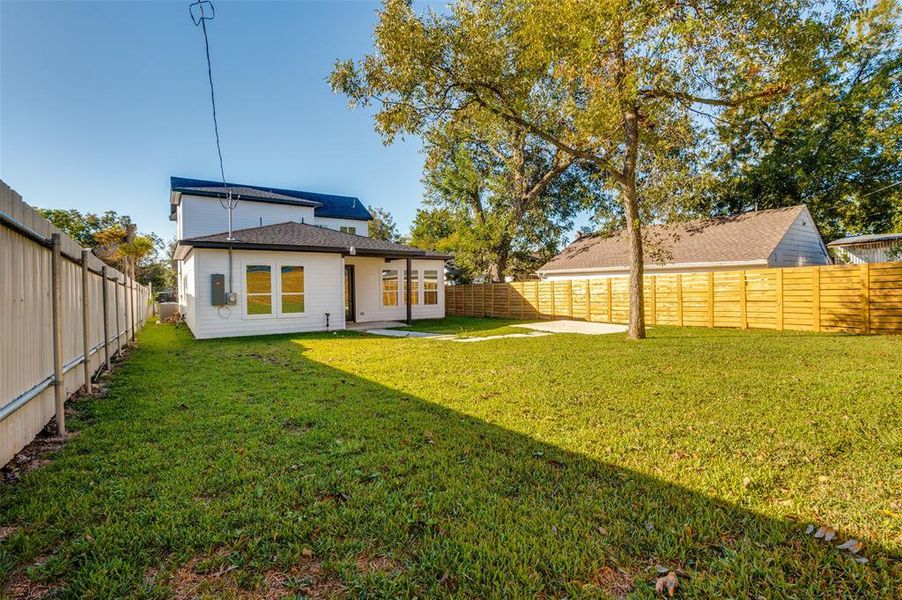 Back of property with a fenced backyard and a patio