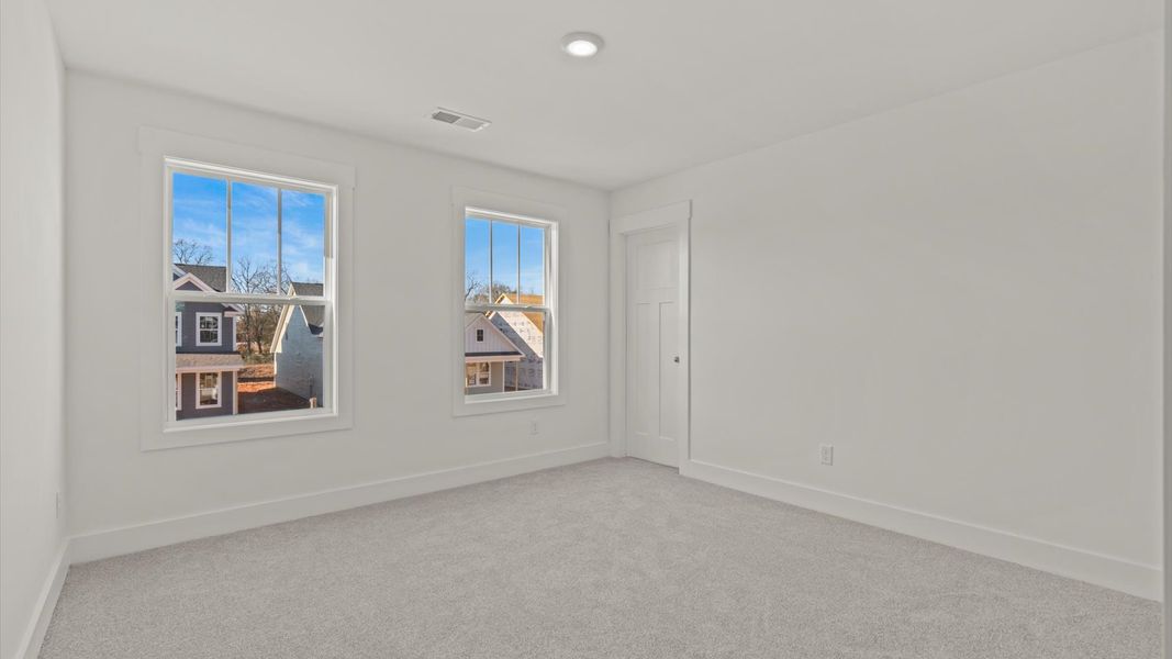 First-class bedroom with generous proportions, a walk-in closet, and beautiful natural light through large windows