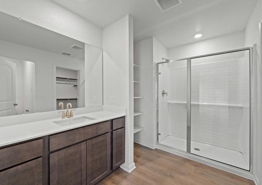 The master bathroom has a large glass, walk-in shower.