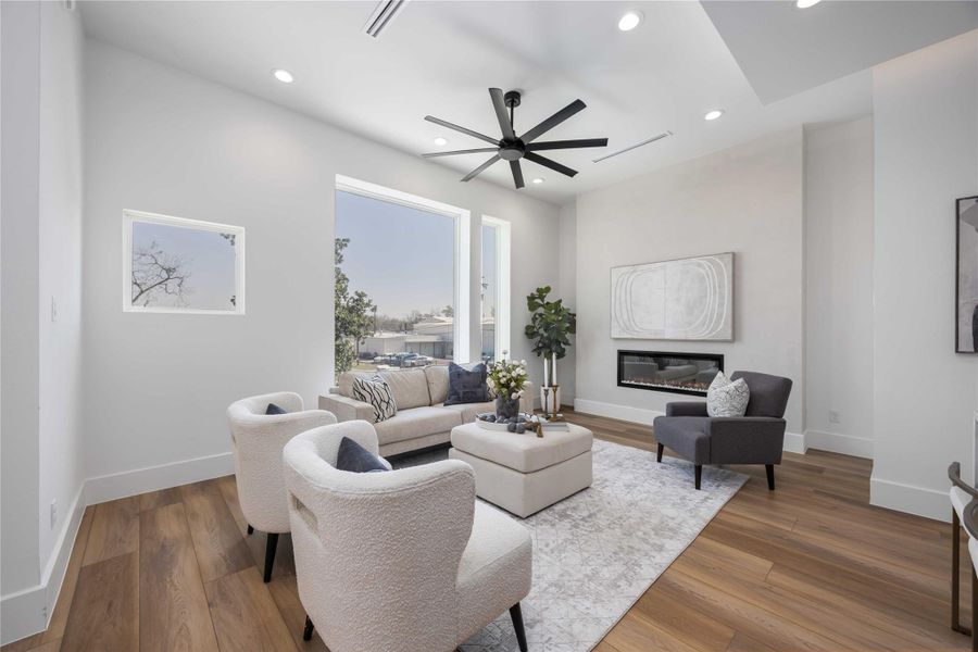 Living room featuring a beautiful subtle plaster accent wall with a modern electric fireplace.