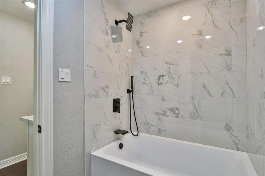 An Expression of Contemporary Living. Upscale bathtub/shower combo fixtures with oversized showerhead and removal handle for convenience.