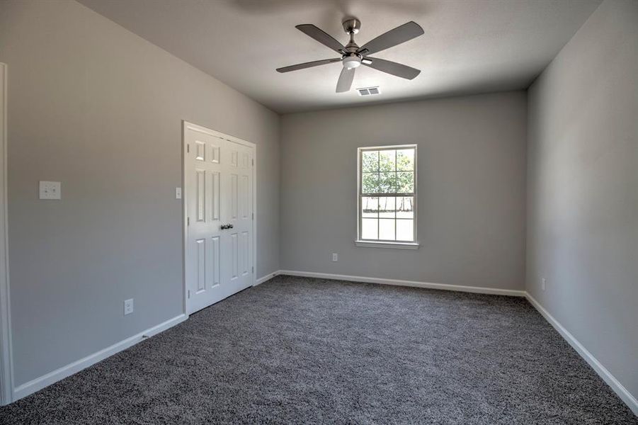 Unfurnished room with carpet floors and ceiling fan