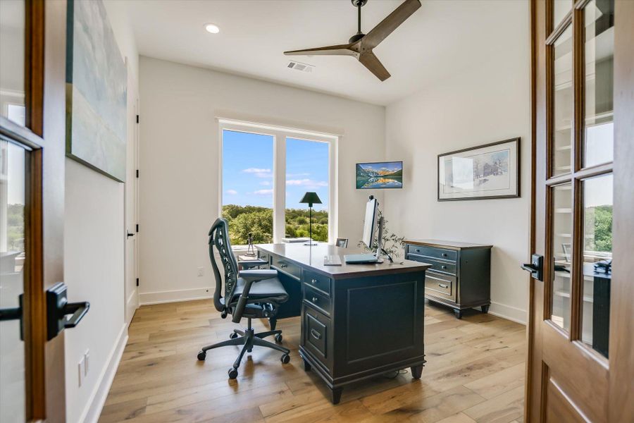 Office space featuring a ceiling fan, recessed lighting, light wood-style floors, baseboards, and french doors Office space featuring a ceiling fan, recessed lighting, light wood-style floors, baseboards, and french doors