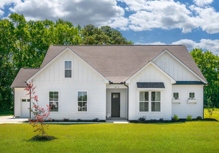 Front exterior of a new home in Dixon Grove, Grimesland, NC, highlighting curb appeal (Image 1).